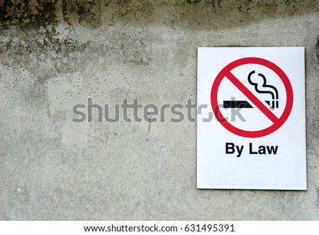 No smoking sign on the cement wall