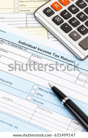 Tax form with pen and calculator; document are mock-up
