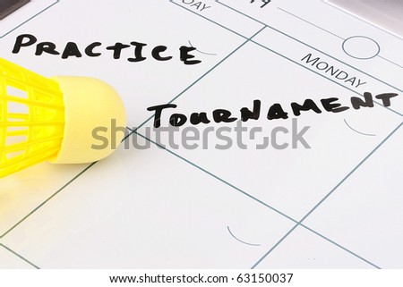 A yellow synthetic shuttlecock on a calendar with a busy schedule.