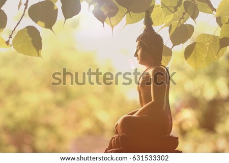 Visakha Puja Day , Buddha statue , bodhi leaf  with double exposure and len flared , soft image and soft focus style Royalty-Free Stock Photo #631533302