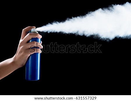 aerosol can spraying on black background Royalty-Free Stock Photo #631557329