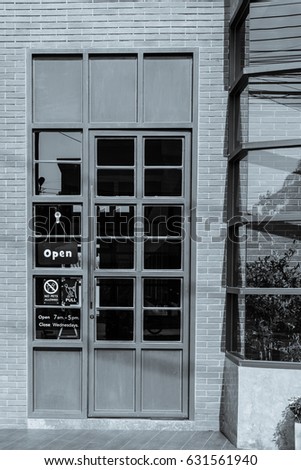 gray iron doors with glass and black brick.and sign 