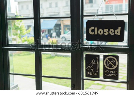 black iron doors with glass and and sign 