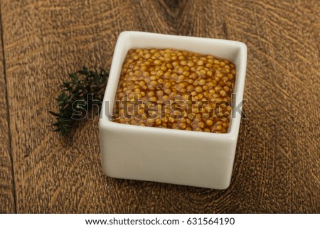 Dijon mustard sauce in the bowl served thyme
