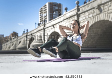 beautiful woman happy doing exercise and working out , abs outdoor