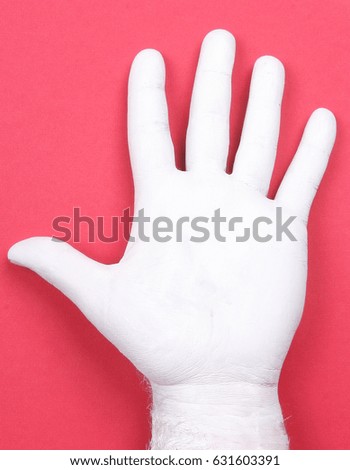 A hand of white color lies on a bright background there is a place for an inscription