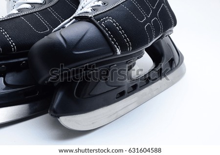 black hockey skates closeup on white background