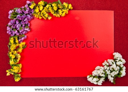 A blank card with fresh flowers. Red background