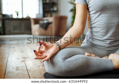 Fit woman doing yoga on mat at home in the bedroom.Young woman meditating indoors.A series of yoga poses. lifestyle concept