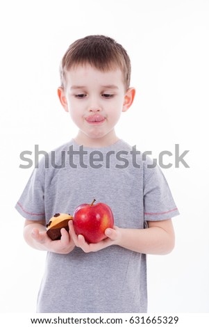 little boy with food isolated on white background - apple or a muffin