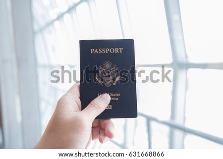 hand hold us passport in the airport Royalty-Free Stock Photo #631668866