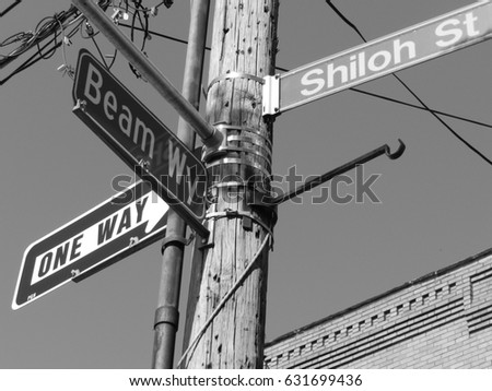 Street signs corner of Beam Way and Shiloh Street with traffic sign one way-grayscale