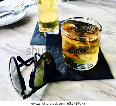 Cold Fresh Whiskey next to a Beer and Sunglasses in Los Angeles.