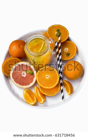 Fresh squeezed orange juice in a jar on blue woodwn table with leaf of mint.top view Copy space.Tropical Background Holiday Travel Bright Toned Design View