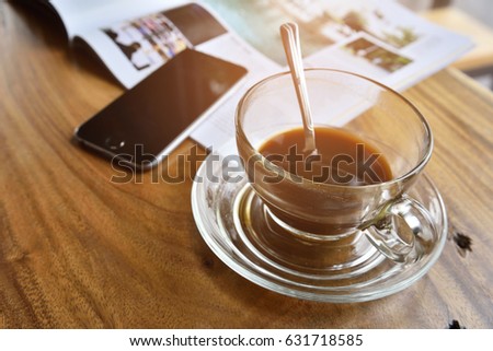 coffe cup and smartphone,book pace on wood desk in office