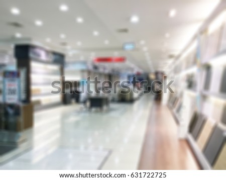 Abstract blurred photo of material store in shopping mall which have ceramic tile and wood tile, laminate , tile, vinyl, showroom materials concept