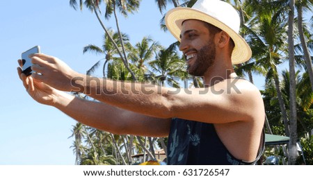 Man taking a selfie in a tropical beach