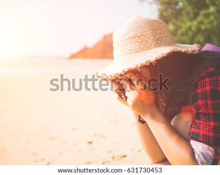 Close up Portrait of beautiful woman with retro hipster camera having fun at the beach.