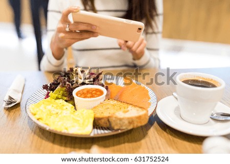Woman taking photo on her meal