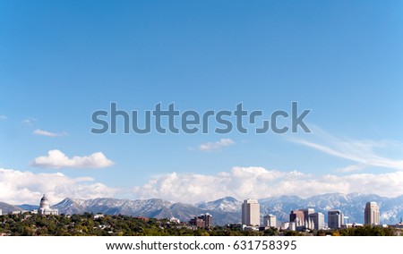 Skyline of Salt Lake City, Utah, including the Utah State Capitol, downtown skyscrapers and the famous Mormon Temple with the Wasatch Mountains in the background. 

Lots of room for type in the image.