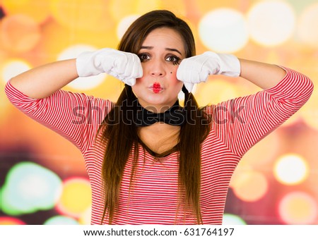 Closeup portrait of female clown mime expressing sadness
