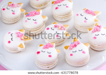 Unicorn macaron cookies on a pink background