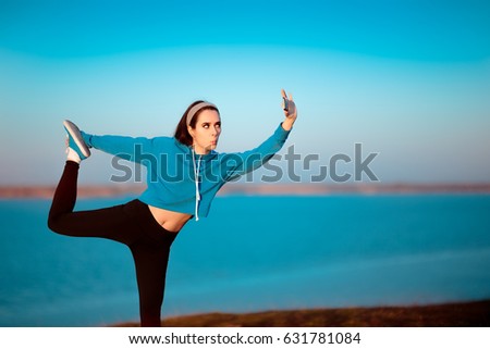 Girl in Yoga Pose Taking a Selfie Outside in Nature - Funny woman posing for her social media profile in a sporty outfit
