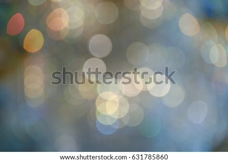 glitter vintage lights background with light burst . silver, blue, gold and white. de-focused.