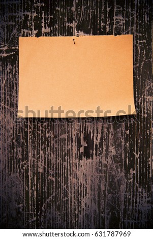 Old brown paper on wood board background 