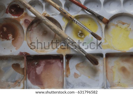 artists brushes and watercolour paints on palette