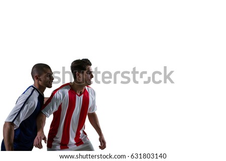 Two football players defending each other while playing soccer against white background
