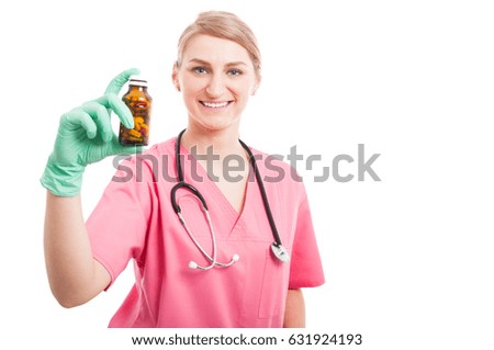 Friendly medical nurse lady smiling showing pills bottle isolated on white background with copy text space