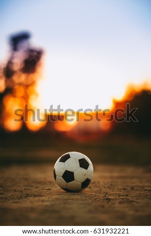 A ball for street soccer football under the sunset ray light. Film picture style.