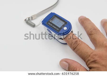 Pulse oximeter in a male patient's fingertip  on white background.