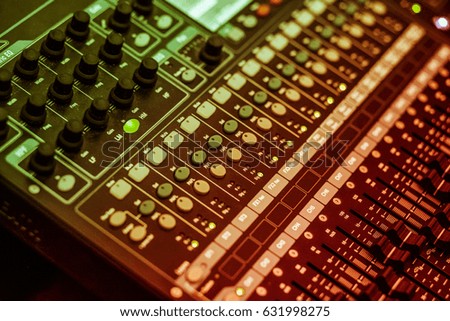 WARNING SHALLOW DEPTH OF FIELD EFFECT (small aperture) audio, a mixing console is an electronic device for combining (also called "mixing"), routing, and changing the volume level, timbre (tone color)