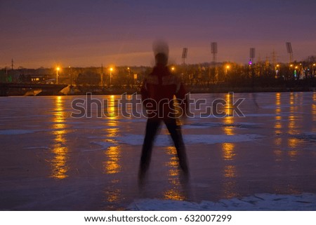 Young man on frozen river at night