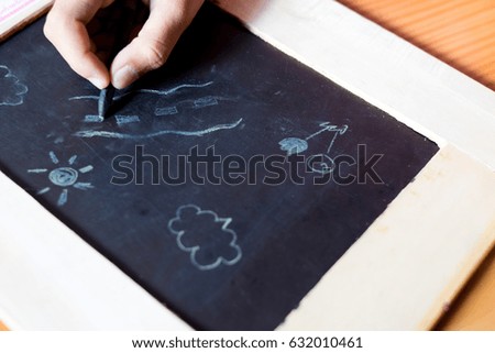 baby draw cartoon with chalk and blackboard