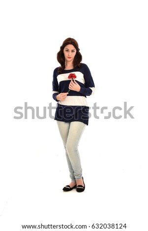 full length portrait of brunette girl wearing jeans and stripped top. isolated against white background.