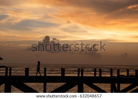 siluate picture women walking on the bridge when sunset time, filling sad or alone