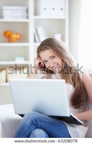 Attractive young girl with a laptop at home