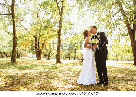 couple bride and groom on a park background.