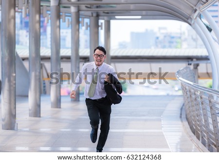 Stressed anxious businessman in a hurry and running, he is late for his business appointment and Wear a shirt while running. Royalty-Free Stock Photo #632124368