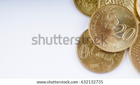 Closeup of heap of gold coins isolated on white background.