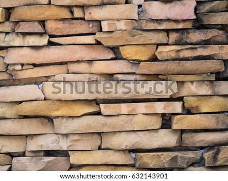 Stone fragments on the wall sealed with cement mortar, Texture background