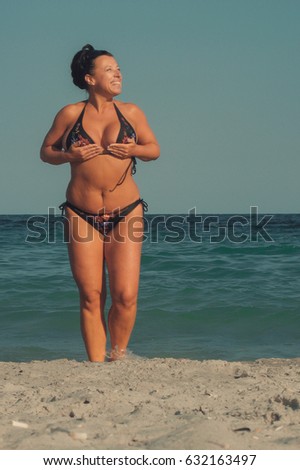 Brunette woman in a swimsuit out of the sea