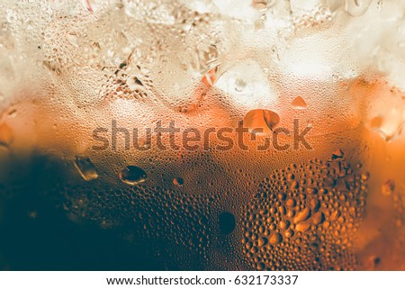 Refreshing Bubbly Soda Pop with Ice Cubes. Cold soda iced drink in a glasses - Selective focus, shallow DOF Royalty-Free Stock Photo #632173337