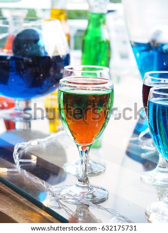 Colorful glass of cocktail on the table in bar.