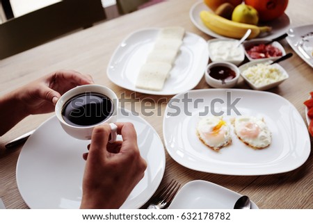 lifestyle image of woman holding coffee, breakfast time