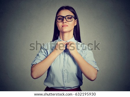 Immaculate woman buttons up her blue shirt 