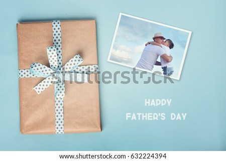 Pictures of father and son and gift box n blue background.